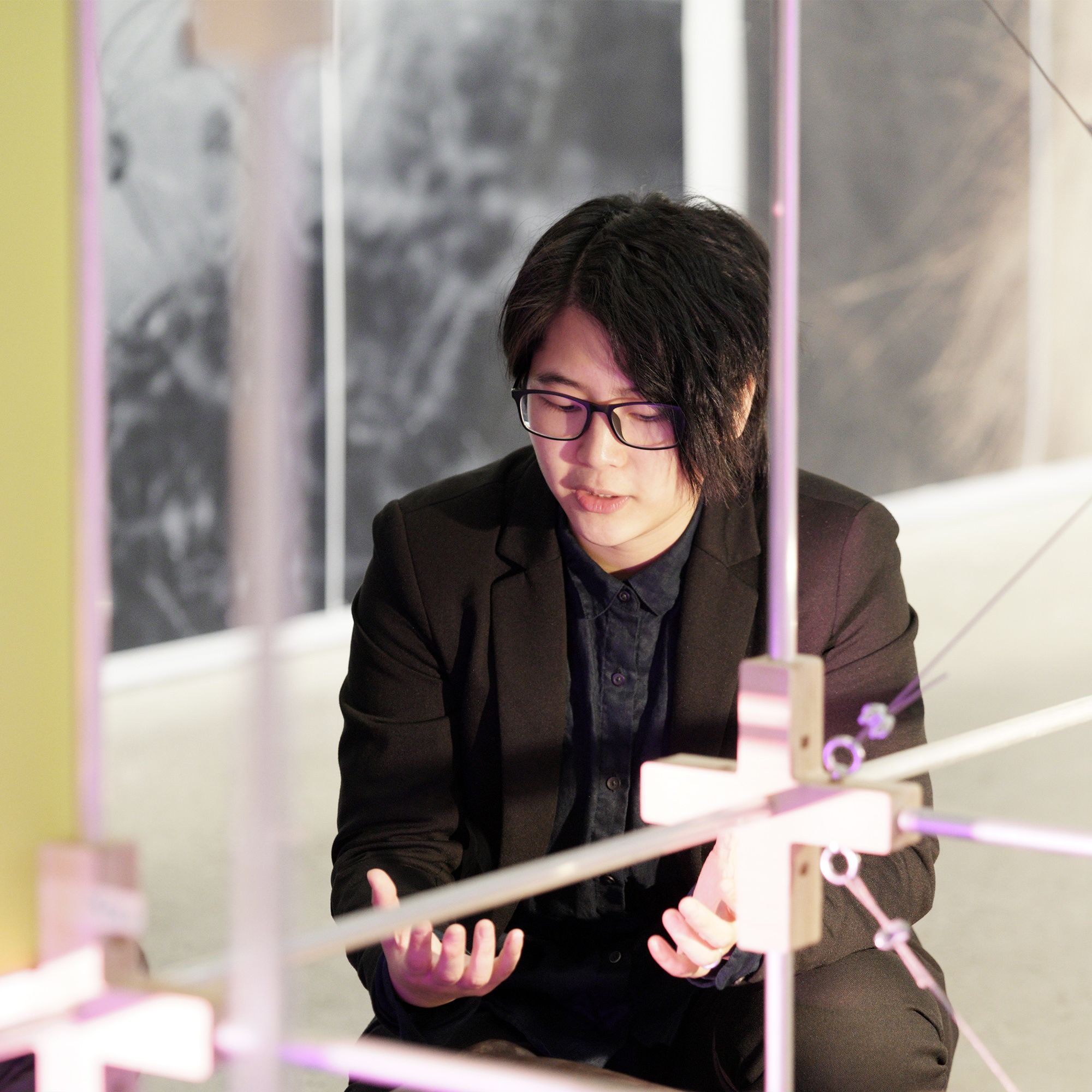 photo of a women through framework with black hair sitting explaining with her hands